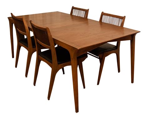 a wooden table with four chairs and one chair on the other side, in front of a white background