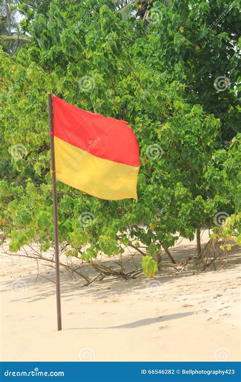 Close Up of a Red and Yellow Safety Flag on an Idyllic Beach Stock Photo - Image of shore, sand ...