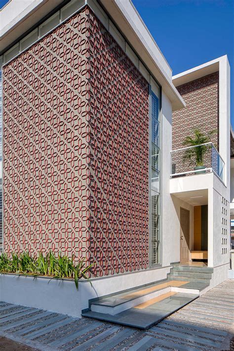 A Patterned Accent Wall Made From Cut Clay Roof Tiles Is Featured On ...