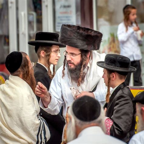 A Group of Hasidim Pilgrims in Traditional Clothing Emotionally Talk. Rosh Hashanah Holiday ...