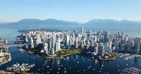 Aerial overlooking downtown and Vancouver skyline with ocean and ...