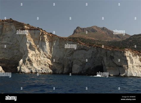 caves on Milos coastline Stock Photo - Alamy