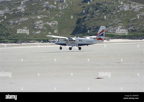 propeller plane landing on beach runway Barra airport Isle of Barra ...