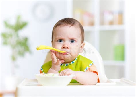 Funny Baby Eating Food on Kitchen Stock Image - Image of kitchen, home ...