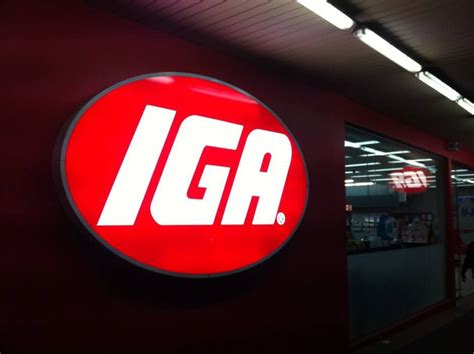 an iga sign is lit up in the dark