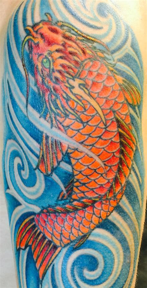 Dark orange Koi fish tattoo in deep blue swirling water. Symbolic of determination and ...