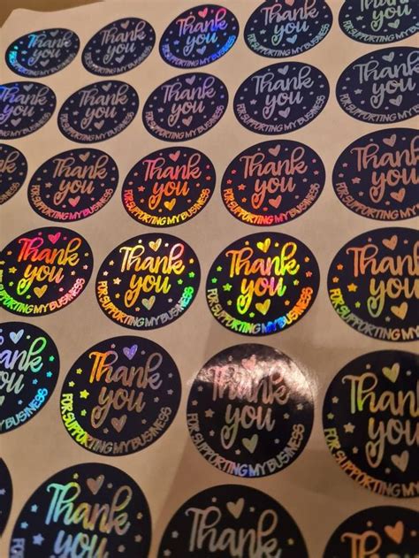 thank you stickers are shown on a table