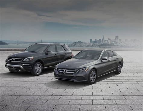 two mercedes benz vehicles parked in front of a cityscape