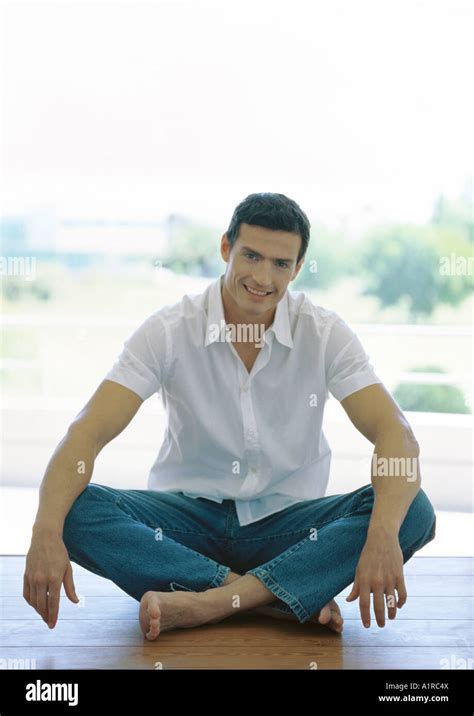 Man sitting indian style on floor Stock Photo - Alamy