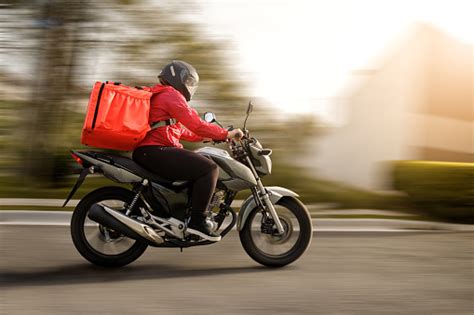 Delivery Biker Arriving At Destination Motogirl Stock Photo - Download ...