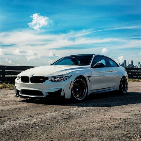 Premium Photo | A white bmw with the license plate number 2 on the front