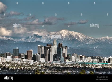 A HDR image of downtown Los Angeles with snow topped mountains in the ...