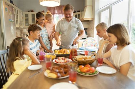 Premium Photo | Big family at the dinner table at home.