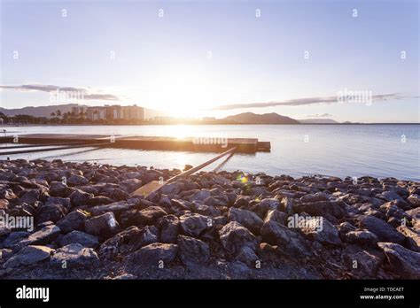 Beautiful rocky beach at sunrise Stock Photo - Alamy