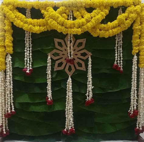 This cute backdrop for Puja is so simple nd elegant💛💚 #pujadecor #traditional #flowers # ...