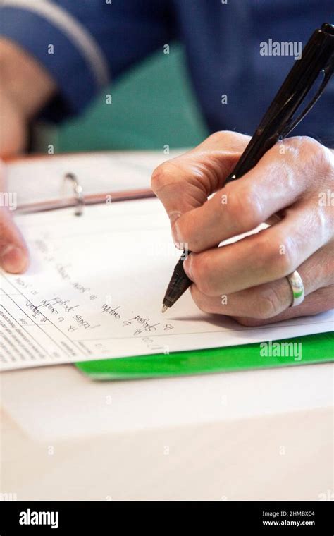 Nurse writing notes Stock Photo - Alamy