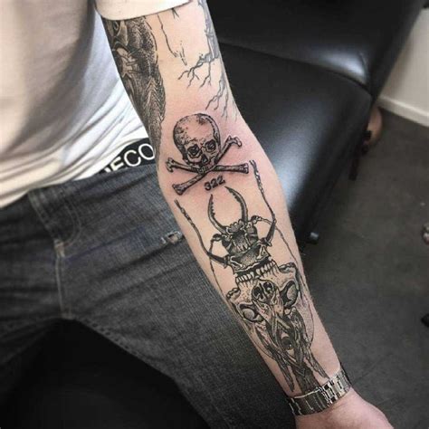 Skull and crossed bones tattoo on the left forearm | Forearm tattoos ...