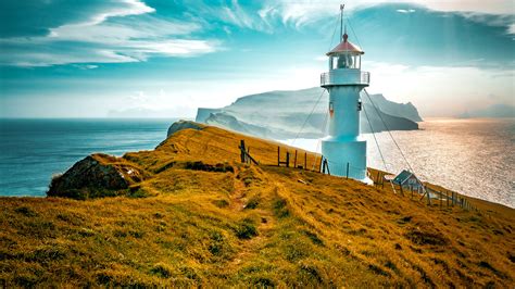 Lighthouse on a cliff at Mykines Island, Faroe Islands, Denmark | Windows Spotlight Images