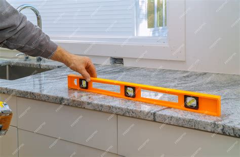 Premium Photo | Installing with granite countertops renovation and ...