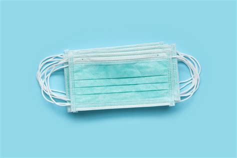 Surgical face mask on blue background protection against COVID-1 - The ...