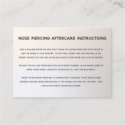 a sign that says nose piercing aftercare instructions on it's white marble surface