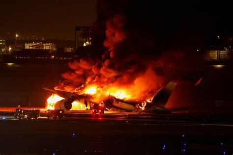 JAL plane on fire after collision with coast guard aircraft at Haneda - Japan Today