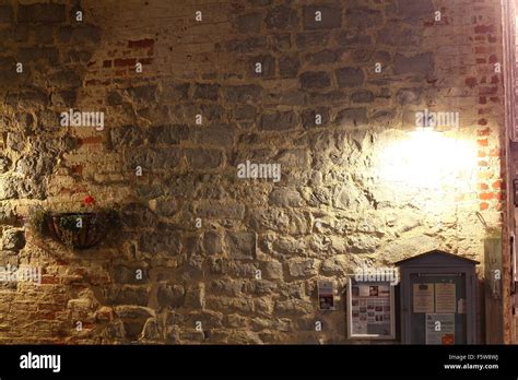 Stone wall at night with light Stock Photo - Alamy