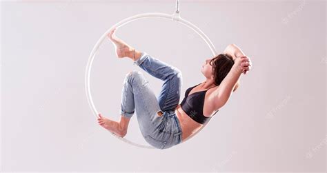 Premium Photo | A female aerial hoop gymnast performing exercises on an ...