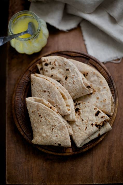 some tortillas are on a wooden plate