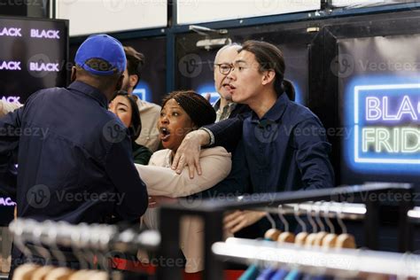 Crowd of diverse people standing at clothing store entrance going crazy ...