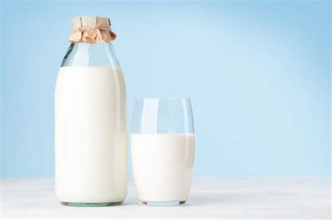 Premium Photo | Milk in glass bottle and cup