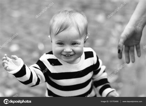 Cute baby boy smiles outdoors — Stock Photo © Tverdohlib.com #131753490