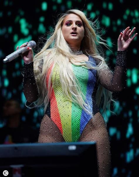 Singer Meghan Trainor is seen wearing a "Pride" bathing suit while ...