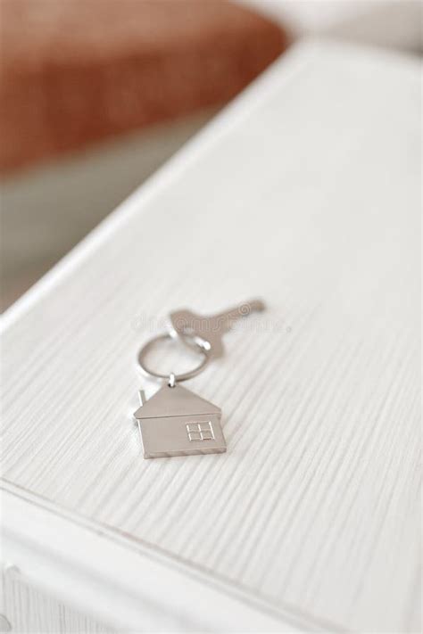 Mortgage Concept. Key with House Keychain on Wooden Table. Modern Light Lobby Interior Stock ...