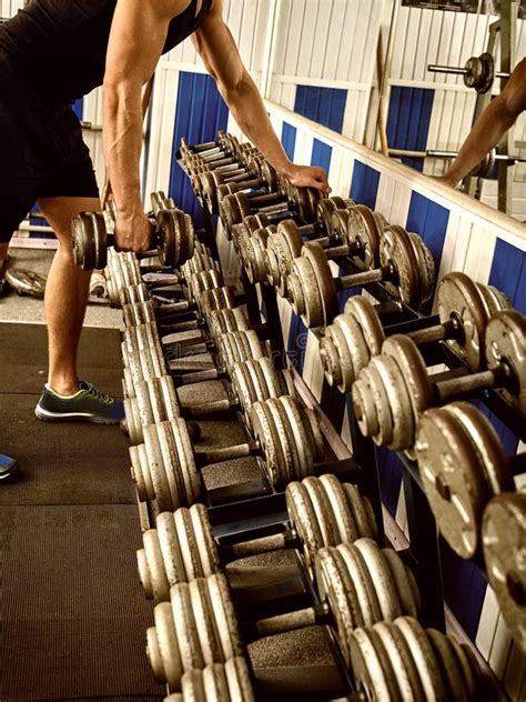 Man in Gym Workout with Fitness Equipment. Cropped Shot. Stock Photo ...