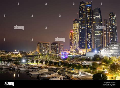 Abu Dhabi Skyline illuminated at night Stock Photo - Alamy