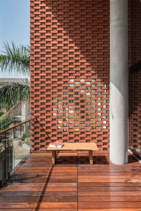 Rippling red brick facade shades house in Surat by Design Work Group ...