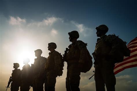 Premium AI Image | Soldiers stand in a line in front of the sun