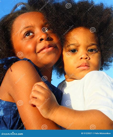 Two Young Children Hugging stock image. Image of hugging - 5123927