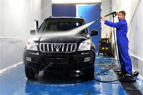 Young man washing his car with compression water – Stock Editorial Photo © grigvovan #61774293