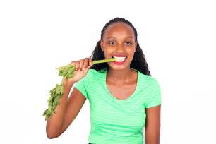 Healthy woman eating celery stalks