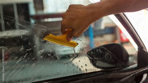 Technician Installing car window tint. Car window tinting series. Car ...