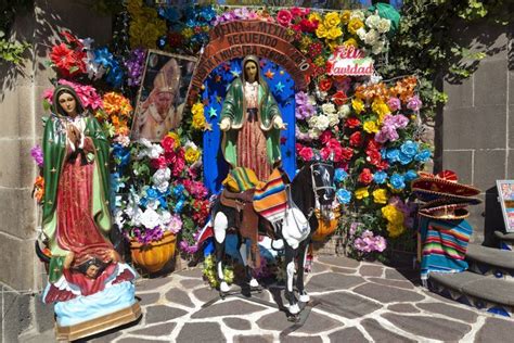 an outdoor shrine decorated with flowers and statues