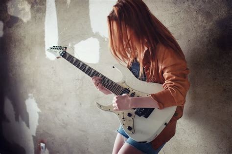 Young Red-haired Girl with an Electric Guitar. Rock Musician Gir Stock ...