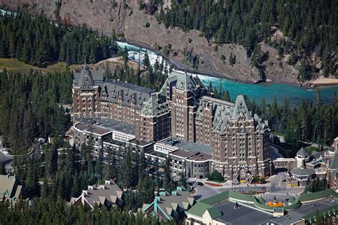 Fairmont Banff Springs Hotel With The Bow River Falls Banff Alberta Canada by George Oze