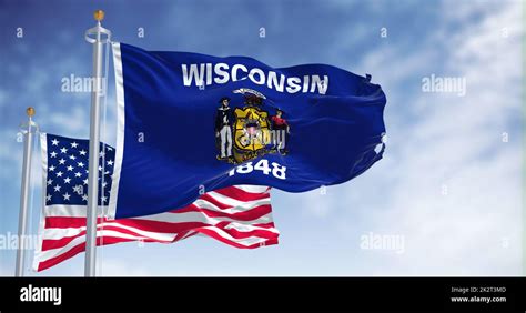 The Wisconsin state flag waving along with the national flag of the United States of America ...