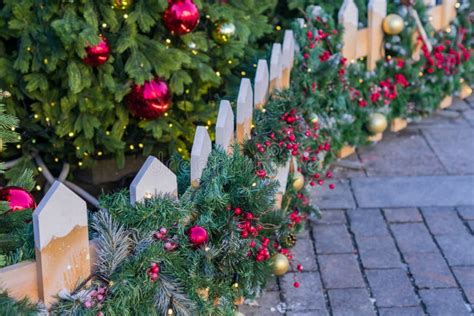 Christmas Outdoors Decoration of Fence. Branches with Balls and Garland ...