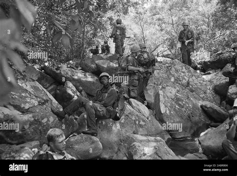 Marines of Company L, 3rd Battalion, 5th Marines, take a rest on rocky ...