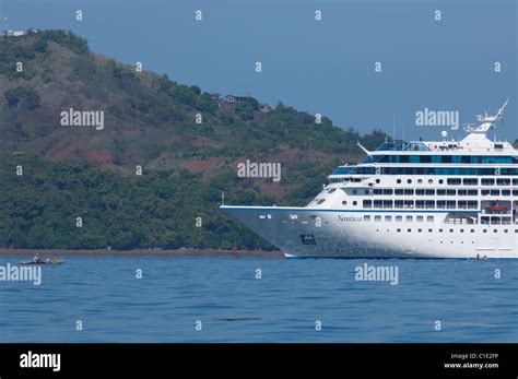 Madagascar, Island of Nosy Be. Oceania cruise ship, Nautica, with small ...