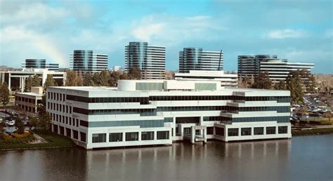 an office building sitting next to a body of water